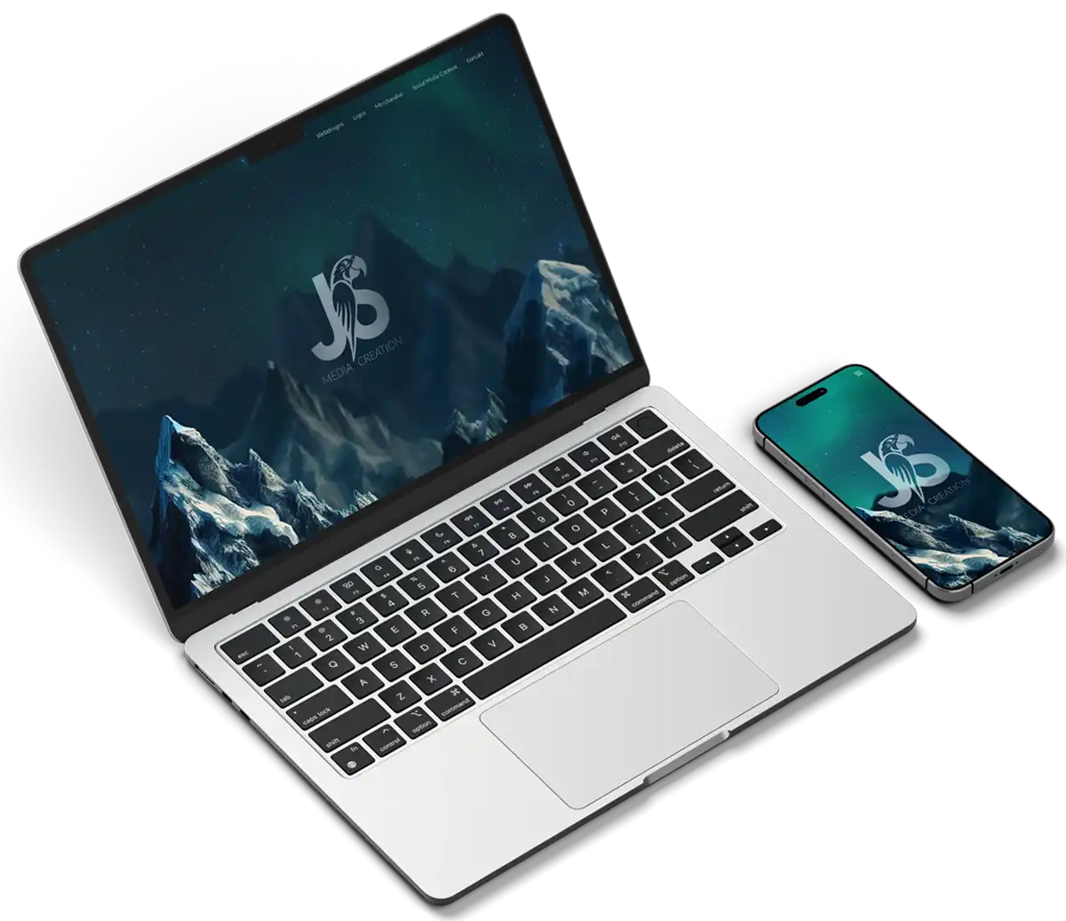 Laptop und Smartphone, die jeweils die JS Media Creation Website anzeigen